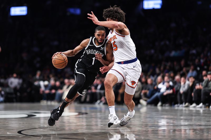 NEW YORK, NEW YORK - JANUARY 23: Mikal Bridges #1 of the Brooklyn Nets is guarded by Jericho Sims #45 of the New York Knicks during the first quarter of the game at Barclays Center on January 23, 2024 in New York City.  NOTE TO USER: User expressly acknowledges and agrees that, by downloading and or using this photograph, User is consenting to the terms and conditions of the Getty Images License Agreement. (Photo by Dustin Satloff/Getty Images)