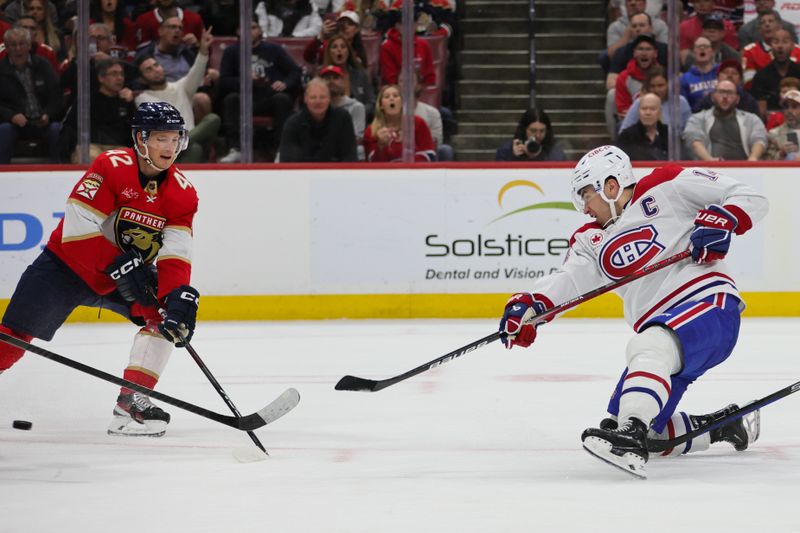 Feb 29, 2024; Sunrise, Florida, USA; Montreal Canadiens center Nick Suzuki (14) shoots the puck against the Florida Panthers during the first period at Amerant Bank Arena. Mandatory Credit: Sam Navarro-USA TODAY Sports