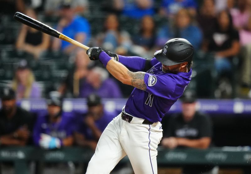Jul 1, 2024; Denver, Colorado, USA; Colorado Rockies outfielder Jake Cave (11) hits a walk off single in the tenth inning against the Milwaukee Brewers at Coors Field. Mandatory Credit: Ron Chenoy-USA TODAY Sports