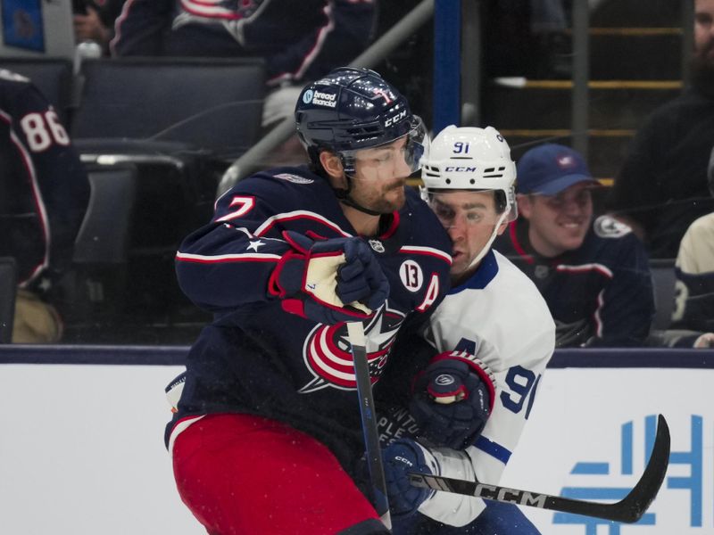 Oct 22, 2024; Columbus, Ohio, USA; Columbus Blue Jackets center Sean Kuraly (7) checks Toronto Maple Leafs center John Tavares (91) during the third period at Nationwide Arena. Mandatory Credit: Aaron Doster-Imagn Images