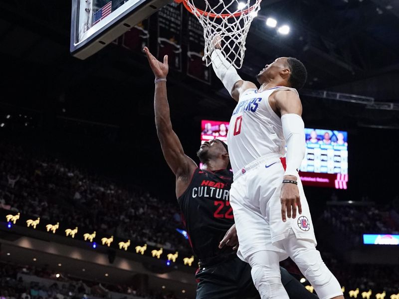 MIAMI, FLORIDA - FEBRUARY 04: Jimmy Butler #22 of the Miami Heat goes up for a shot against Russell Westbrook #0 of the LA Clippers during the second quarter at Kaseya Center on February 04, 2024 in Miami, Florida. User expressly acknowledges and agrees that, by downloading and or using this photograph, User is consenting to the terms and conditions of the Getty Images License Agreement. (Photo by Rich Storry/Getty Images)