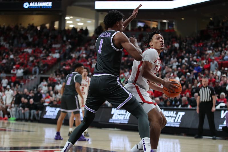 Jan 13, 2024; Lubbock, Texas, USA;  Texas Tech Red Raiders guard D Maurian Williams (5) looks to the basket against Kansas State Wildcats wing David N Guessan (1) in the first half at United Supermarkets Arena. Mandatory Credit: Michael C. Johnson-USA TODAY Sports