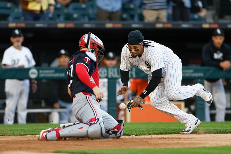 Apr 30, 2024; Chicago, Illinois, USA; Chicago White Sox catcher Martín Maldonado (15) slides to score but is tagged out by Minnesota Twins catcher Ryan Jeffers (27) during the third inning at Guaranteed Rate Field. Mandatory Credit: Kamil Krzaczynski-USA TODAY Sports