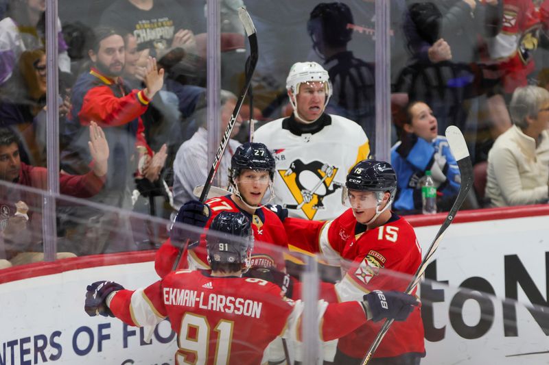 Dec 8, 2023; Sunrise, Florida, USA; Florida Panthers center Eetu Luostarinen (27) celebrates after scoring against the Pittsburgh Penguins during the third period at Amerant Bank Arena. Mandatory Credit: Sam Navarro-USA TODAY Sports