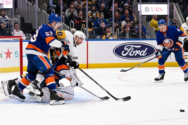 Apr 17, 2024; Elmont, New York, USA;  New York Islanders center Casey Cizikas (53) checks Pittsburgh Penguins defenseman Marcus Pettersson (28) into New York Islanders goaltender Ilya Sorokin (30) during the third period at UBS Arena. Mandatory Credit: Dennis Schneidler-USA TODAY Sports