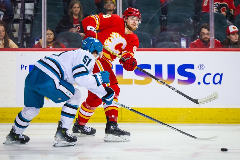 Apr 18, 2024; Calgary, Alberta, CAN; Calgary Flames defenseman Ilya Solovyov (98) passes the puck in front of San Jose Sharks right wing Collin Graf (51) during the first period at Scotiabank Saddledome. Mandatory Credit: Sergei Belski-USA TODAY Sports