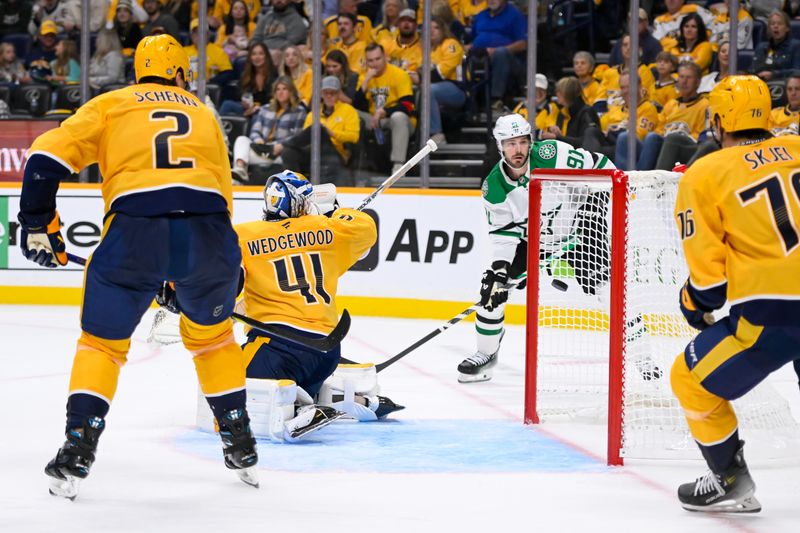 Oct 10, 2024; Nashville, Tennessee, USA;  Nashville Predators goaltender Scott Wedgewood (41) deflects the puck against the Dallas Stars during the second period at Bridgestone Arena. Mandatory Credit: Steve Roberts-Imagn Images