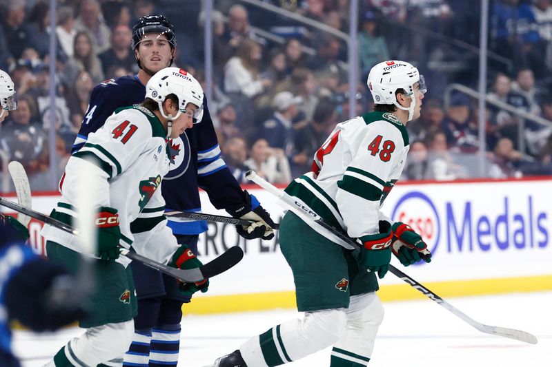 Sep 21, 2024; Winnipeg, Manitoba, CAN; Minnesota Wild defenseman Daemon Hunt (48) celebrates his first period goal against the Winnipeg Jets at Canada Life Centre. Mandatory Credit: James Carey Lauder-Imagn Images