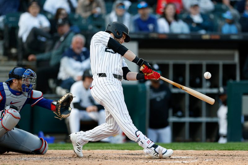 May 24, 2025; Chicago, Illinois, USA; Chicago White Sox designated hitter Andrew Benintendi (23) hits a two-run double against the Texas Rangers during the sixth inning at Rate Field. Mandatory Credit: Kamil Krzaczynski-Imagn Images