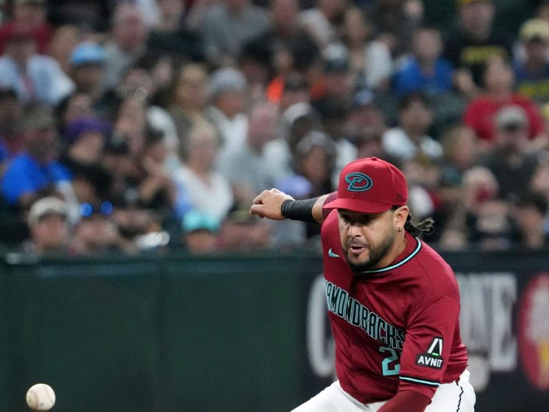 Jul 28, 2024; Phoenix, Arizona, USA; Arizona Diamondbacks third base Eugenio Suárez (28) fields a ground ball against the Pittsburgh Pirates during the first inning at Chase Field. Mandatory Credit: Joe Camporeale-USA TODAY Sports