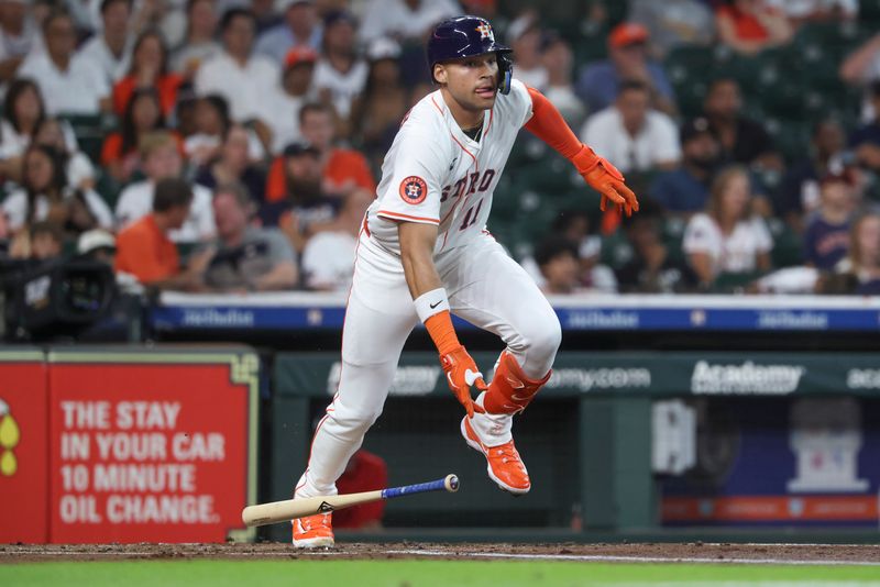 Jul 29, 2025; Houston, Texas, USA; Houston Astros right fielder Cam Smith (11) hits an RBI double during the first inning against the Washington Nationals at Daikin Park. Mandatory Credit: Troy Taormina-Imagn Images
