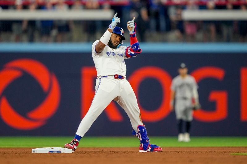 Jun 29, 2024; Toronto, Ontario, CAN; Toronto Blue Jays first base Vladimir Guerrero Jr. (27) celebrates after hitting a double against the New York Yankees during the sixth inning at Rogers Centre. Mandatory Credit: Kevin Sousa-USA TODAY Sports