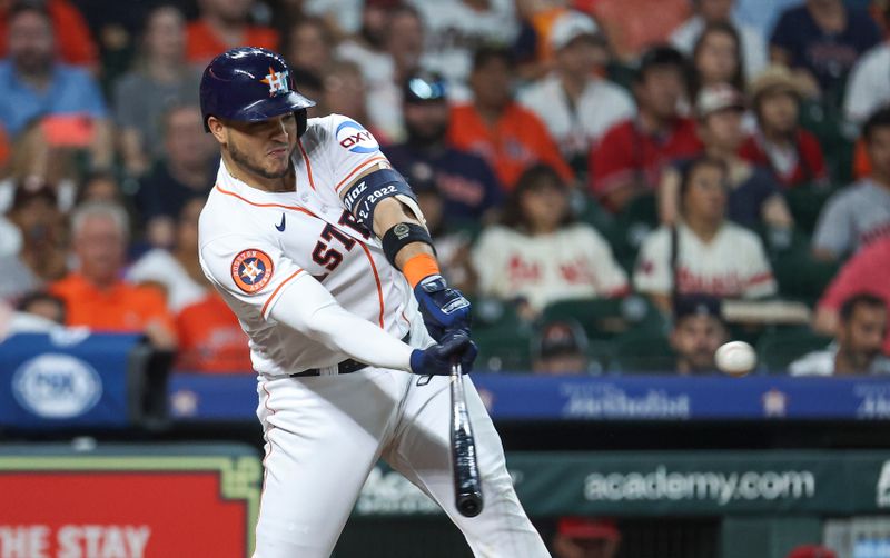 Aug 12, 2023; Houston, Texas, USA; Houston Astros catcher Yainer Diaz (21) hits an RBI single during the fifth inning against the Los Angeles Angels at Minute Maid Park. Mandatory Credit: Troy Taormina-USA TODAY Sports