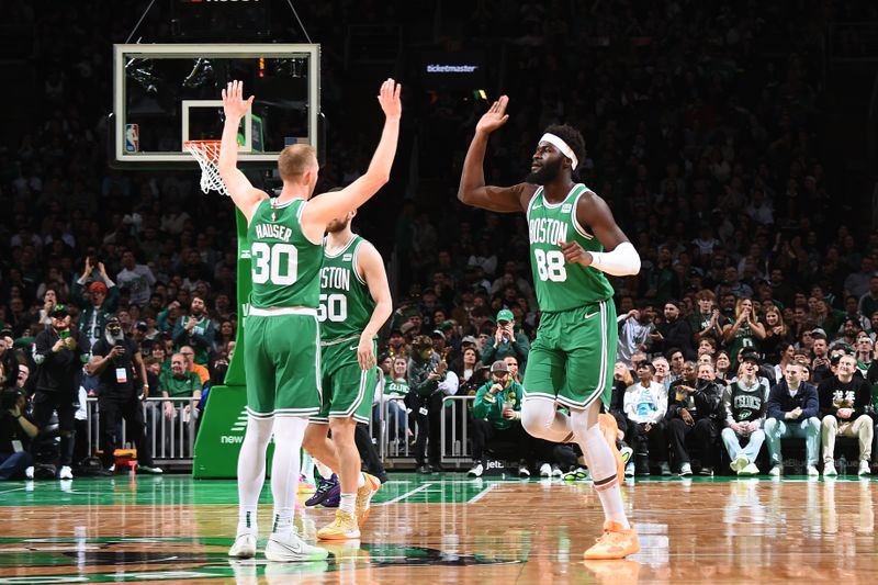 BOSTON, MA - APRIL 12:  Sam Hauser #30 high fives  Neemias Queta #88 of the Boston Celtics during the game against the Charlotte Hornets on April 12, 2024 at the TD Garden in Boston, Massachusetts. NOTE TO USER: User expressly acknowledges and agrees that, by downloading and or using this photograph, User is consenting to the terms and conditions of the Getty Images License Agreement. Mandatory Copyright Notice: Copyright 2024 NBAE  (Photo by Brian Babineau/NBAE via Getty Images)