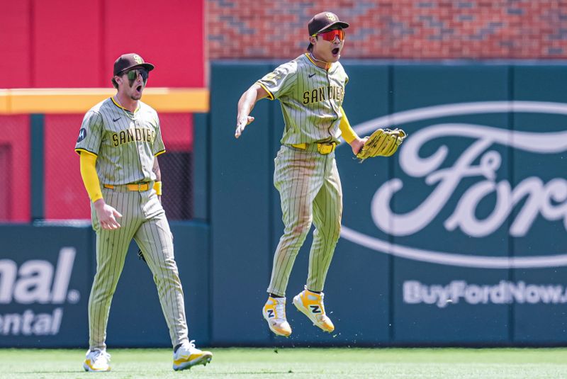 May 20, 2024; Cumberland, Georgia, USA; San Diego Padres shortstop Ha-Seong Kim (7) (right) reacts along with center fielder Jackson Merrill (3) after making a diving catch on a ball hit by Atlanta Braves center fielder Michael Harris II (23) (not shown) during the ninth inning at Truist Park. Mandatory Credit: Dale Zanine-USA TODAY Sports