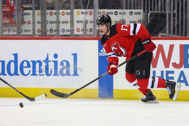 Mar 21, 2024; Newark, New Jersey, USA; New Jersey Devils defenseman Simon Nemec (17) skates with the puck against the Winnipeg Jets during the first period at Prudential Center. Mandatory Credit: Ed Mulholland-USA TODAY Sports