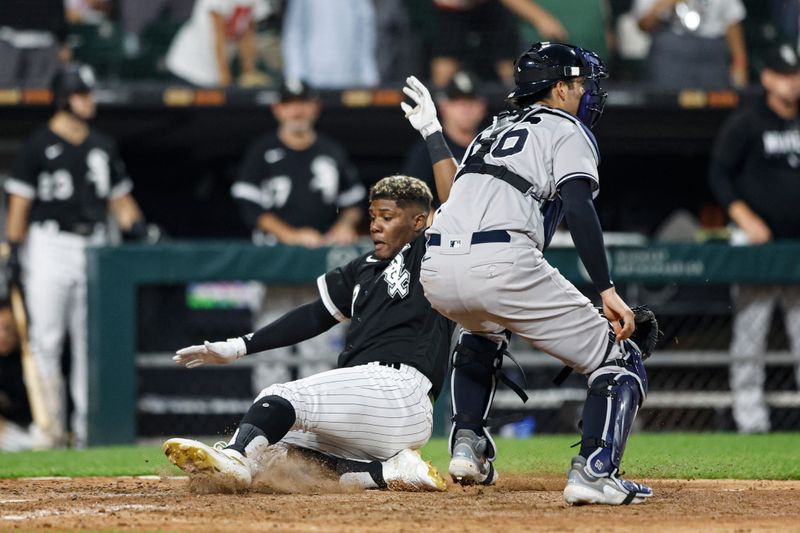 Aug 9, 2023; Chicago, Illinois, USA; Chicago White Sox right fielder Oscar Colas (22) scores against the New York Yankees during the eight inning at Guaranteed Rate Field. Mandatory Credit: Kamil Krzaczynski-USA TODAY Sports