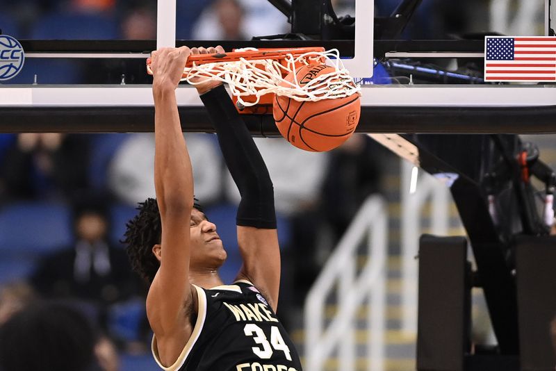 Mar 8, 2023; Greensboro, NC, USA; Wake Forest Demon Deacons forward Bobi Klintman (34) scores in the second half of the second round at Greensboro Coliseum. Mandatory Credit: Bob Donnan-USA TODAY Sports