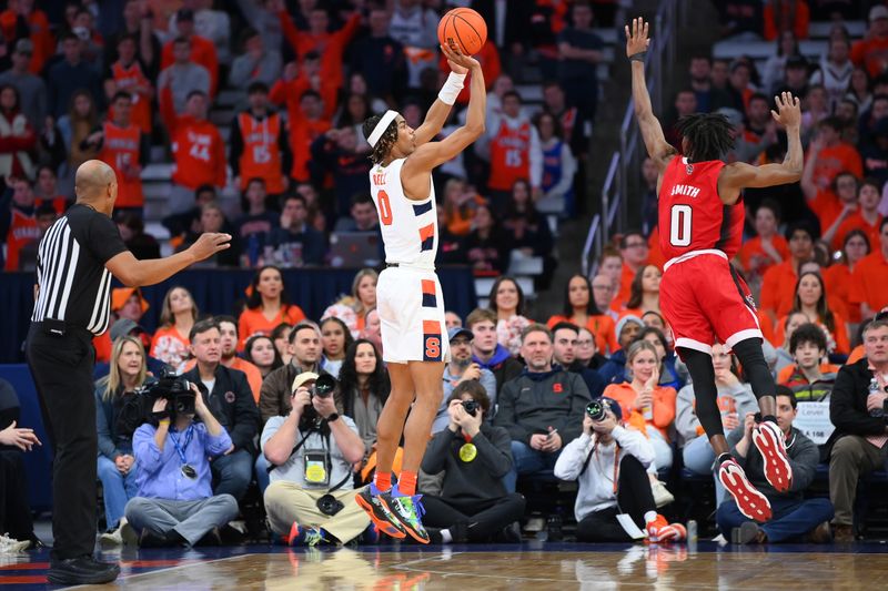 Feb 14, 2023; Syracuse, New York, USA; Syracuse Orange forward Chris Bell (0) shoots the ball against the defense of North Carolina State Wolfpack guard Terquavion Smith (0) during the second half at the JMA Wireless Dome. Mandatory Credit: Rich Barnes-USA TODAY Sports