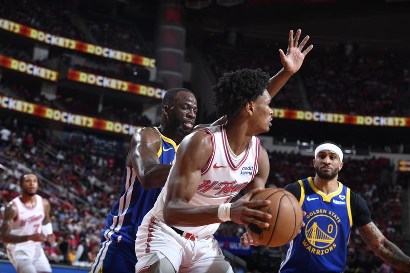 HOUSTON, TX - APRIL 4: Amen Thompson #1 of the Houston Rockets handles the ball against Draymond Green #23 of the Golden State Warriors during the game on April 4, 2024 at the Toyota Center in Houston, Texas. NOTE TO USER: User expressly acknowledges and agrees that, by downloading and or using this photograph, User is consenting to the terms and conditions of the Getty Images License Agreement. Mandatory Copyright Notice: Copyright 2024 NBAE (Photo by Logan Riely/NBAE via Getty Images)