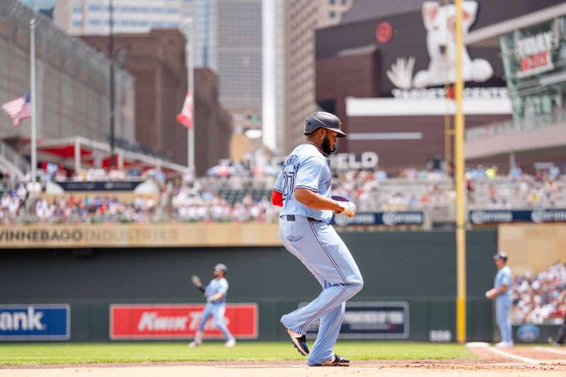 Jun 7, 2025; Minneapolis, Minnesota, USA; Toronto Blue Jays first base Vladimir Guerrero Jr. (27) scores off a single by Toronto Blue Jays outfielder Nathan Lukes (38), hitting a pitch from Minnesota Twins starting pitcher Chris Paddack (20) in the first inning at Target Field. Mandatory Credit: Matt Blewett-Imagn Images
