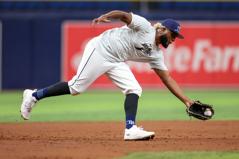 Aug 13, 2024; St. Petersburg, Florida, USA; Tampa Bay Rays third baseman Junior Caminero (13) takes fielding practice before a game against the Houston Astros at Tropicana Field. Mandatory Credit: Nathan Ray Seebeck-USA TODAY Sports