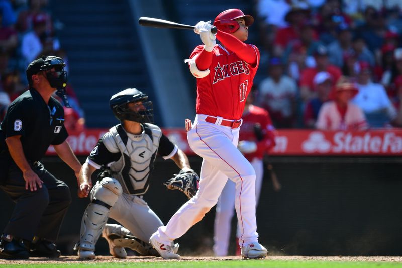 Jun 29, 2023; Anaheim, California, USA; Los Angeles Angels designated hitter Shohei Ohtani (17) hits a two run home run against the Chicago White Sox during the ninth inning at Angel Stadium. Mandatory Credit: Gary A. Vasquez-USA TODAY Sports