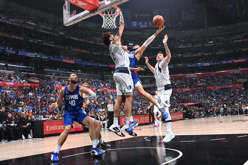 LOS ANGELES, CA - APRIL 21: Amir Coffey #7 of the LA Clippers drives to the basket during the game against the Dallas Mavericks during the 2024 NBA Playoffs on April 21, 2024 at Crypto.Com Arena in Los Angeles, California. NOTE TO USER: User expressly acknowledges and agrees that, by downloading and/or using this Photograph, user is consenting to the terms and conditions of the Getty Images License Agreement. Mandatory Copyright Notice: Copyright 2024 NBAE (Photo by Andrew D. Bernstein/NBAE via Getty Images)