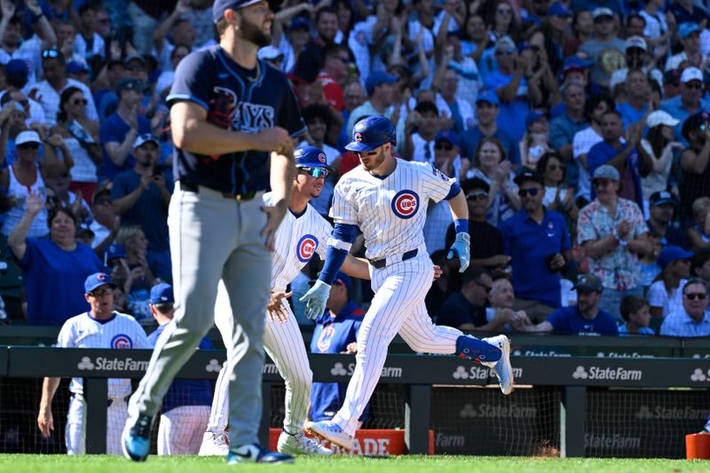 Sep 14, 2025; Chicago, Illinois, USA;  Chicago Cubs outfielder Ian Happ (8) celebrates with third base coach Quintin Berry (0)  as Tampa Bay Rays pitcher Adrian Houser (37) walks towards the mound after a home run during the sixth inning at Wrigley Field. Mandatory Credit: Matt Marton-Imagn Images