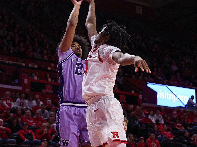 Feb 24, 2026; Piscataway, New Jersey, USA; Washington Huskies center Lathan Sommerville (24) shoots the ball as Rutgers Scarlet Knights forward Dylan Grant (9) defends during the first half at Jersey Mike's Arena. Mandatory Credit: Vincent Carchietta-Imagn Images