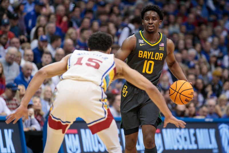 Feb 18, 2023; Lawrence, Kansas, USA; Baylor Bears guard Adam Flagler (10) looks to get around Kansas Jayhawks guard Kevin McCullar Jr. (15) during the first half at Allen Fieldhouse. Mandatory Credit: William Purnell-USA TODAY Sports