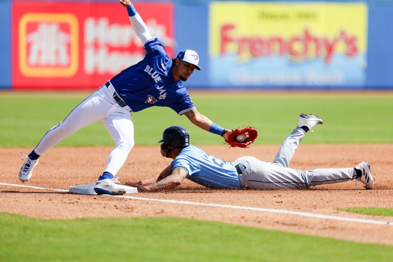 Feb 28, 2024; Dunedin, Florida, USA;  Tampa Bay Rays center fielder Jose Siri (22) steals second base from Toronto Blue Jays third baseman Santiago Espinal (5) in the second inning  at TD Ballpark. Mandatory Credit: Nathan Ray Seebeck-USA TODAY Sports