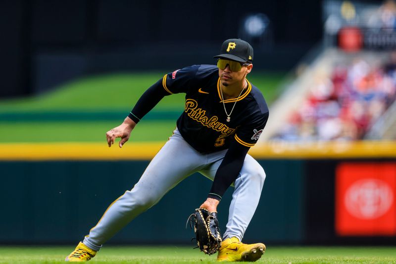Apr 13, 2025; Cincinnati, Ohio, USA; Pittsburgh Pirates first baseman Endy Rodriguez (5) grounds the ball hit by Cincinnati Reds outfielder TJ Friedl (not pictured) in the seventh inning at Great American Ball Park. Mandatory Credit: Katie Stratman-Imagn Images
