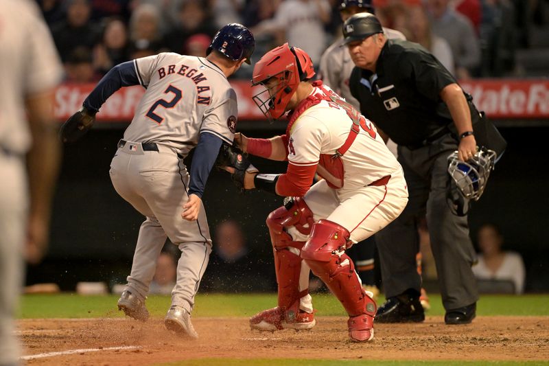 Jun 8, 2024; Anaheim, California, USA;  Houston Astros third baseman Alex Bregman (2) is tagged out at home by Los Angeles Angels catcher Matt Thaiss (21) in the third inning at Angel Stadium. Mandatory Credit: Jayne Kamin-Oncea-USA TODAY Sports