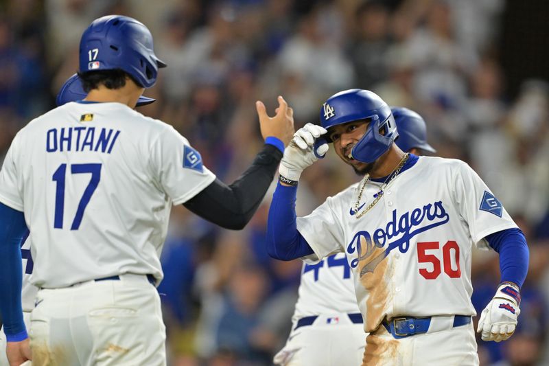 Sep 10, 2025; Los Angeles, California, USA; Los Angeles Dodgers shortstop Mookie Betts (50) is greeted at the plate by designated hitter Shohei Ohtani (17) after hitting a grand slam home run during the eighth inning against the Colorado Rockies at Dodger Stadium. Mandatory Credit: Jayne Kamin-Oncea-Imagn Images
