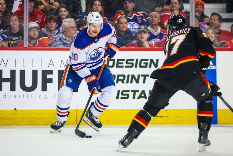 Apr 6, 2024; Calgary, Alberta, CAN; Edmonton Oilers left wing Zach Hyman (18) controls the puck against Calgary Flames center Yegor Sharangovich (17) during the second period at Scotiabank Saddledome. Mandatory Credit: Sergei Belski-USA TODAY Sports