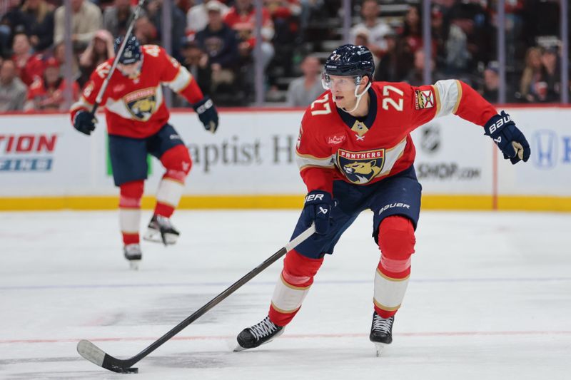 Nov 1, 2025; Sunrise, Florida, USA; Florida Panthers center Eetu Luostarinen (27) moves the puck against the Dallas Stars during the second period at Amerant Bank Arena. Mandatory Credit: Sam Navarro-Imagn Images