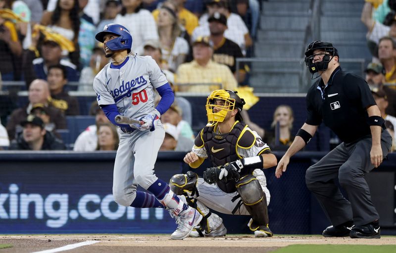 Oct 9, 2024; San Diego, California, USA; Los Angeles Dodgers shortstop Mookie Betts (50) hits a home run in the first inning against the San Diego Padres during game four of the NLDS for the 2024 MLB Playoffs at Petco Park. Mandatory Credit: David Frerker-Imagn Images