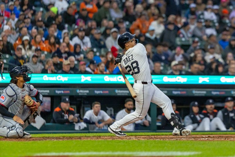 May 22, 2025; Detroit, Michigan, USA; Detroit Tigers outfielder Javier Báez (28) hits a single off of Cleveland Guardians pitcher Tanner Bibee (28) and breaks his bat in the third inning at Comerica Park. Mandatory Credit: David Reginek-Imagn Images