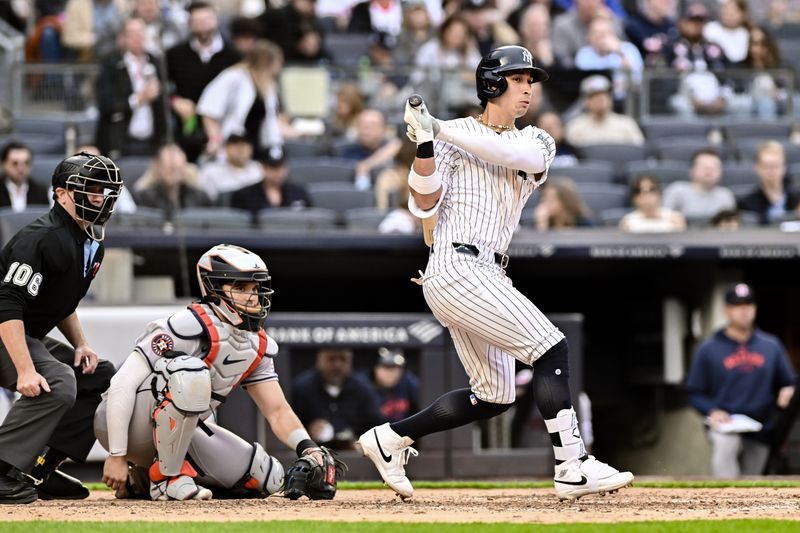 May 9, 2024; Bronx, New York, USA; New York Yankees third baseman Oswaldo Cabrera (95) hits a single against the Houston Astros during the fifth inning at Yankee Stadium. Mandatory Credit: John Jones-USA TODAY Sports