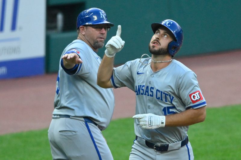 Aug 27, 2024; Cleveland, Ohio, USA; Kansas City Royals third baseman Paul DeJong (15) celebrates his two-run home run with third base coach Vance Wilson (25) in the second inning against the Cleveland Guardians at Progressive Field. Mandatory Credit: David Richard-USA TODAY Sports