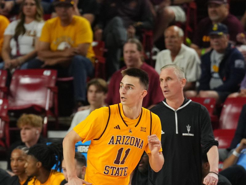 Feb 26, 2025; Tempe, Arizona, USA; Arizona State Sun Devils guard Bobby Hurley (11) runs by Arizona State Sun Devils head coach Bobby Hurley during the first half against the Brigham Young Cougars at Desert Financial Arena. Mandatory Credit: Joe Camporeale-Imagn Images