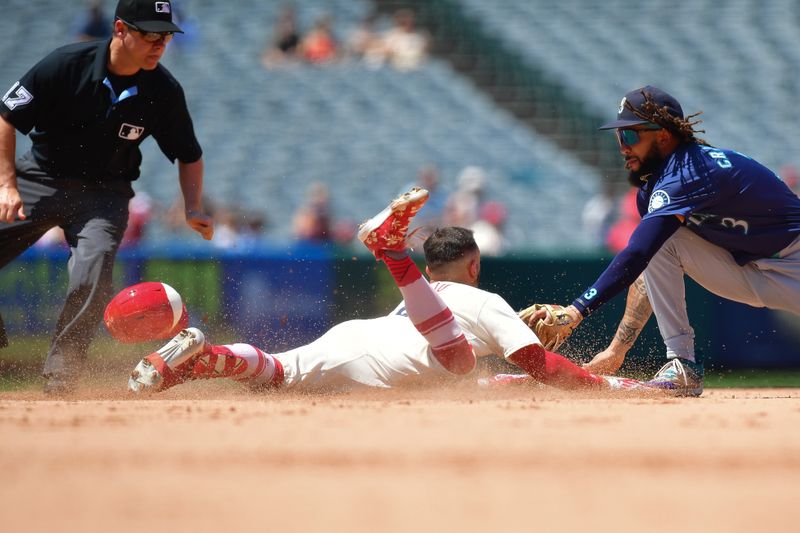 Jul 14, 2024; Anaheim, California, USA; Los Angeles Angels shortstop Zach Neto (9) reaches second on a double against Seattle Mariners shortstop J.P. Crawford (3) during the fifth inning at Angel Stadium. Mandatory Credit: Gary A. Vasquez-USA TODAY Sports