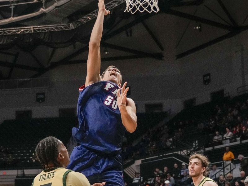 Jan 6, 2024; Charlotte, North Carolina, USA; Florida Atlantic Owls center Vladislav Goldin (50) takes a shot guarded by Charlotte 49ers guard Isaiah Folkes (5) during the second half at Dale F. Halton Arena. Mandatory Credit: Jim Dedmon-USA TODAY Sports