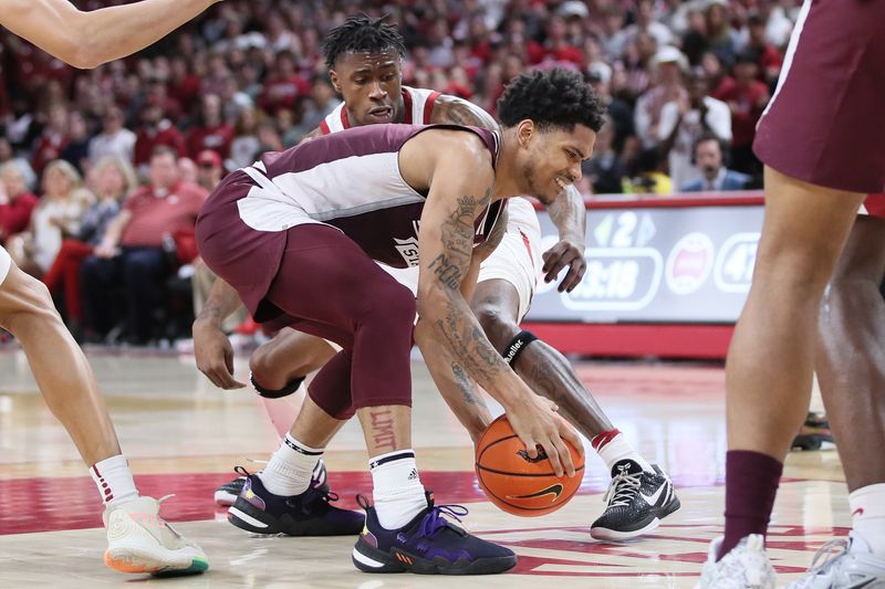 Feb 11, 2023; Fayetteville, Arkansas, USA; Mississippi State Bulldogs guard Shekel Moore (3) and Arkansas Razorbacks guard Davonte Davis reach for a loose ball during the second half at Bud Walton Arena. The Bulldogs won 70-64. Mandatory Credit: Nelson Chenault-USA TODAY Sports