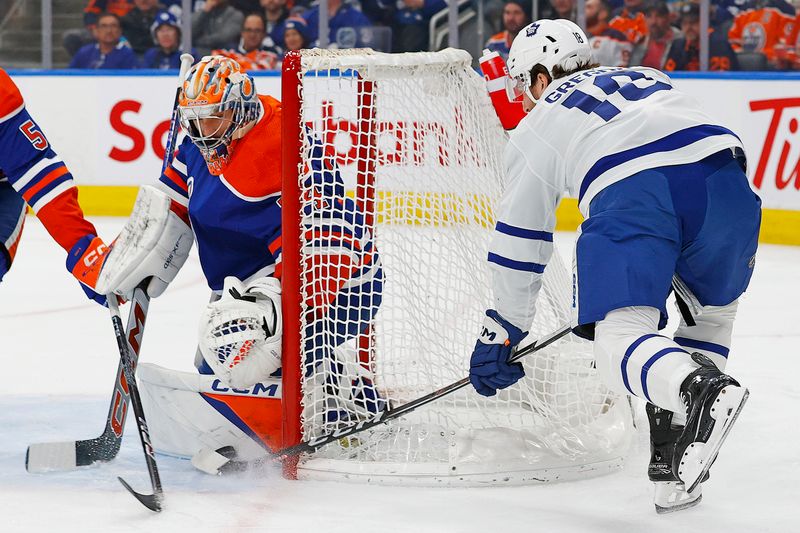 Jan 16, 2024; Edmonton, Alberta, CAN; Toronto Maple Leafs forward Noah Gregor (18) is stopped by Edmonton Oilers goaltender Stuart Skinner (74) during the second period at Rogers Place. Mandatory Credit: Perry Nelson-USA TODAY Sports