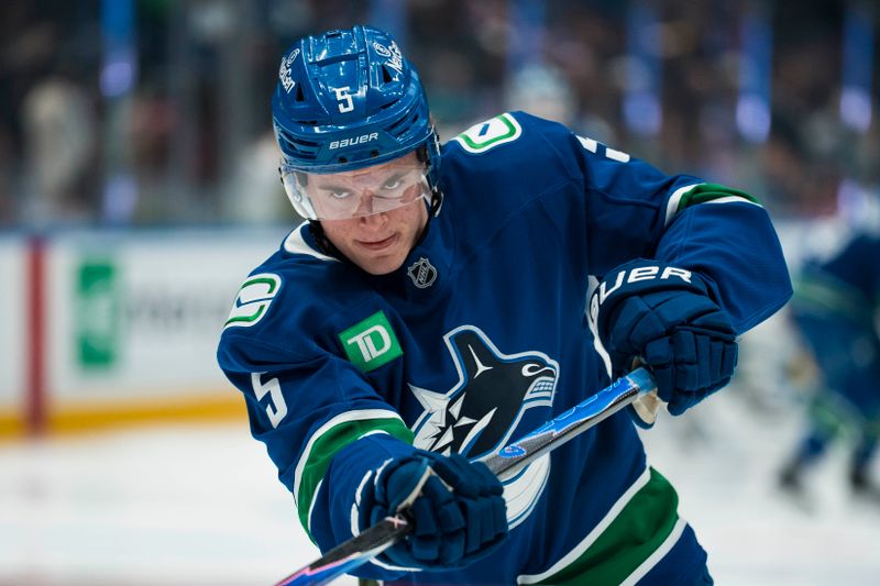 Dec 27, 2025; Vancouver, British Columbia, CAN; Vancouver Canucks defenseman Tom Willander (5) shoots in warm up prior to a game against the San Jose Sharks at Rogers Arena. Mandatory Credit: Bob Frid-Imagn Images