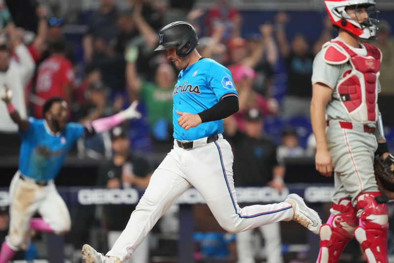 May 12, 2024; Miami, Florida, USA;  Miami Marlins catcher Nick Fortes (4) scores the winning run in the tenth inning against the Philadelphia Phillies at loanDepot Park. Mandatory Credit: Jim Rassol-USA TODAY Sports