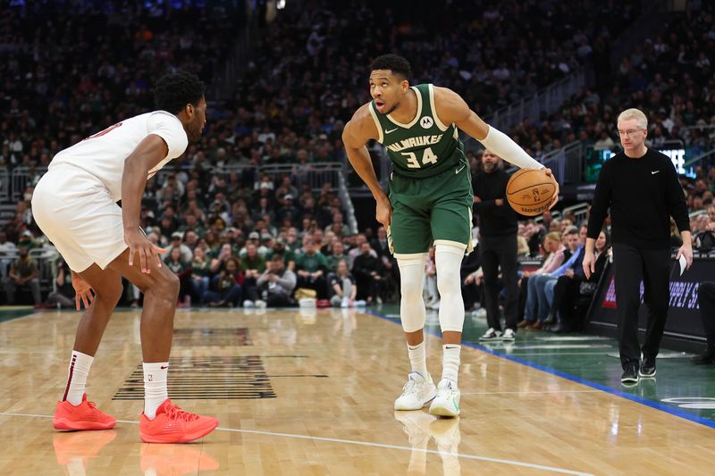 MILWAUKEE, WISCONSIN - JANUARY 24: Giannis Antetokounmpo #34 of the Milwaukee Bucks is defended by Damian Jones #30 of the Cleveland Cavaliers during a game at Fiserv Forum on January 24, 2024 in Milwaukee, Wisconsin. NOTE TO USER: User expressly acknowledges and agrees that, by downloading and or using this photograph, User is consenting to the terms and conditions of the Getty Images License Agreement. (Photo by Stacy Revere/Getty Images)