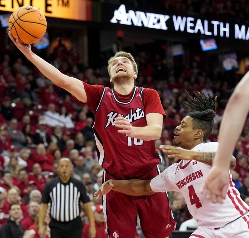 Feb. 18, 2023; Madison, WI, USA; Rutgers Scarlet Knights guard Cam Spencer (10) scores on Wisconsin Badgers guard Kamari McGee (4) during the first half at the Kohl Center in Madison, Wis. Mandatory Credit: Mark Hoffman-USA TODAY Sports